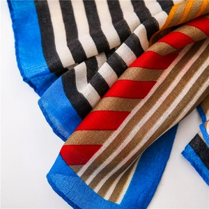 Macro shot of colorful striped scarf showing fine fiber texture and royal blue hem details