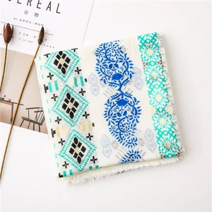 Detailed view of bohemian floral print scarf with soft white tassels and gold foil finish