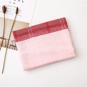 Detail of pink houndstooth scarf with soft fabric texture and artistic lifestyle props
