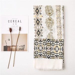 Detailed view of bohemian linen shawl with paisley prints and delicate fringe edges