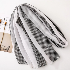 Close-up of lightweight houndstooth and striped scarf with elegant magazine props