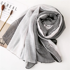 Detail showing sheer houndstooth fabric texture with neat edge stitching and soft finish