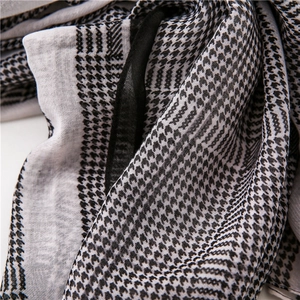 Detail of soft houndstooth pattern chiffon scarf with delicate black hem edge