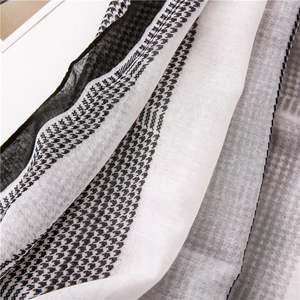 Close-up of lightweight houndstooth scarf showing fine fabric texture and hem detail