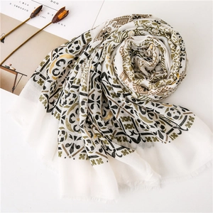 Detailed texture of cotton linen scarf with paisley gold stamping and fringe edges