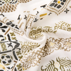 Detail of bohemian cotton linen scarf with golden patterns and soft textile texture