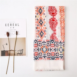 Close-up of cotton linen scarf with ethnic paisley patterns and delicate white fringe