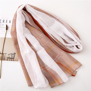 Detail of thin houndstooth scarf with orange stripes and elegant fabric texture