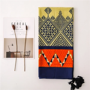 Ethnic geometric print scarf with tassels in yellow and navy blue flat lay design