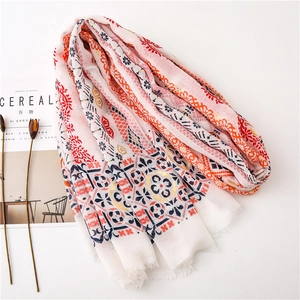 Detail of bohemian cotton linen scarf with ethnic floral patterns and fringe edge