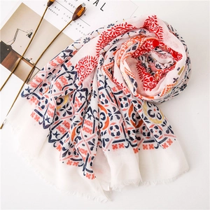 Detail of cotton linen scarf with geometric ethnic print and subtle fringed edges