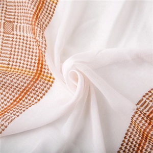 Detail showing the soft texture and brown houndstooth pattern on this lightweight scarf