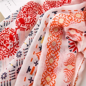 Close-up of pink cotton linen scarf with ethnic floral patterns and gold foil detail