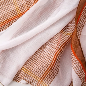 Close-up of lightweight houndstooth scarf showing breathable fabric texture and fine hem