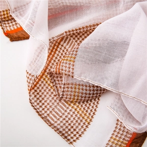 Close-up of lightweight hounds-tooth scarf showing fabric weave and edge stitching