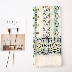 Detail of bohemian cotton linen scarf with geometric patterns and fringe tassels