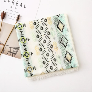 Detail of bohemian cotton linen scarf with gold stamp paisley and tassel edges