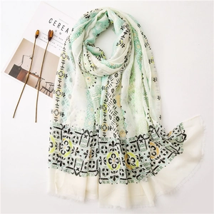 Detail of bohemian cotton linen scarf with gold foil paisley patterns and fringe edges