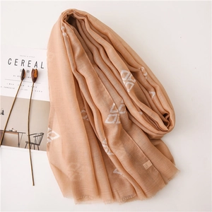 Light brown cotton scarf with white geometric diamond pattern and fringed edges