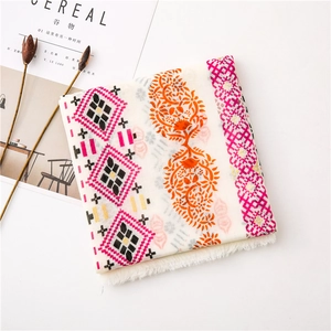 Detail of bohemian cotton linen scarf with floral print and white tassel edges