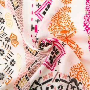 Detailed close-up of bohemian paisley printed cotton linen scarf with gold foil accents