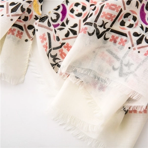 Detailed close-up of cotton linen scarf with ethnic paisley patterns and fringe edges