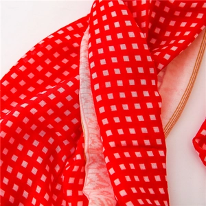 Detail shot of classic red and white checkered pattern fabric with fine striped edges