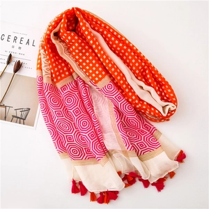 Flat lay of a rectangular scarf with orange checkered patterns and colorful fringe tassels