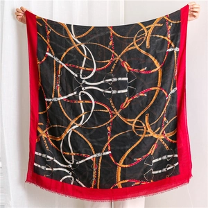 Detail of cotton linen scarf with chain print and fringe edges in red and black
