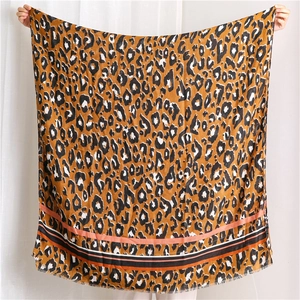 Close-up of leopard print shawl featuring color-block stripes and delicate frayed edges