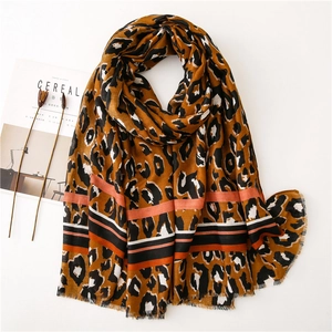 Leopard print scarf with tri-color striped hem and frayed edges on white background