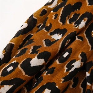 Detail shot showing the leopard print pattern and soft twill weave texture of the scarf