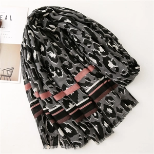 Detailed view of leopard print scarf with horizontal pink stripes and fringed edges