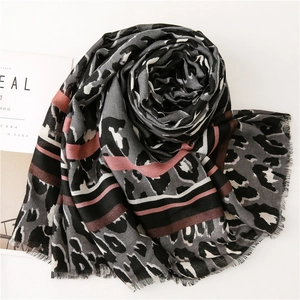 Detail view of pink and grey leopard print scarf with fine fringe edges and cotton-linen texture