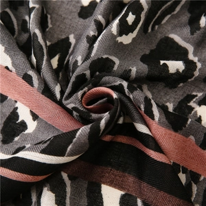 Close-up of leopard print scarf fabric showing soft cotton linen texture and pink stripes
