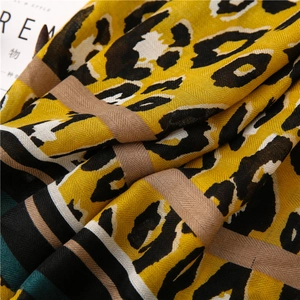 Detail of leopard print and color block pattern on soft breathable scarf fabric