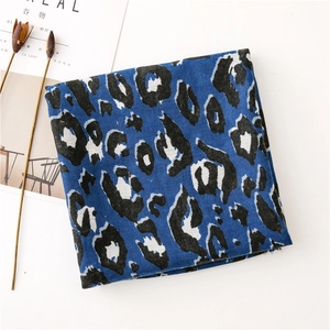 Detailed view of leopard print scarf in royal blue on aesthetic magazine background