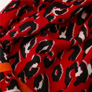 Close-up of red leopard print scarf showing detailed twill texture and bold pattern