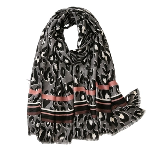 Women's leopard print scarf with colorful stripes and fringe edges on white background