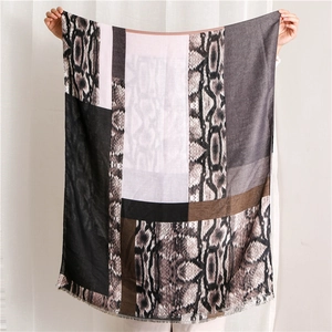 Close-up of leopard and python print cotton scarf with fringe and color-block design