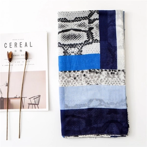 Detail of grey leopard and blue geometric scarf made of soft 100% viscose fabric