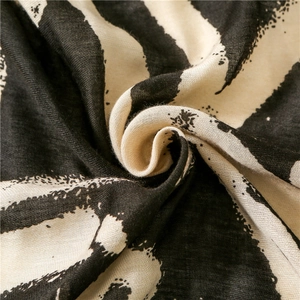 Lightweight cotton linen scarf with black and white graffiti print and woven texture