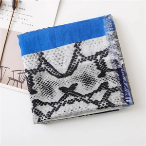 Detail of snake print scarf with royal blue block and delicate frayed fringe edges