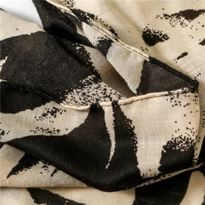 Detail shot of lightweight cotton linen scarf showing zebra graffiti and hem stitching