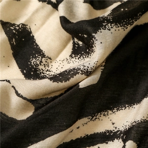 Detail of soft cotton linen fabric with artistic black and white graffiti print