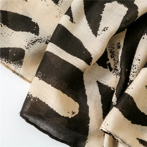 Macro shot of breathable cotton linen fabric with abstract black and white graffiti print