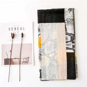 Close-up of color-block scarf with grey-coffee leopard pattern and soft cotton-linen texture