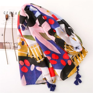 Detail of abstract tropical print scarf with colorful patterns and navy blue fringes
