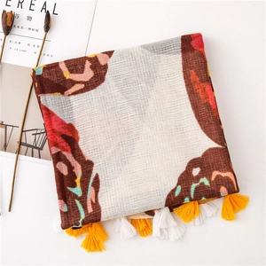 Detailed texture of ethnic print cotton linen scarf with soft fringe tassels and breathable weave