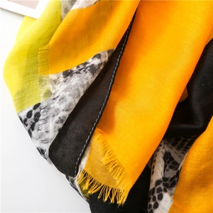 Detailed macro view of the colorful leopard print scarf fabric with fringed edges